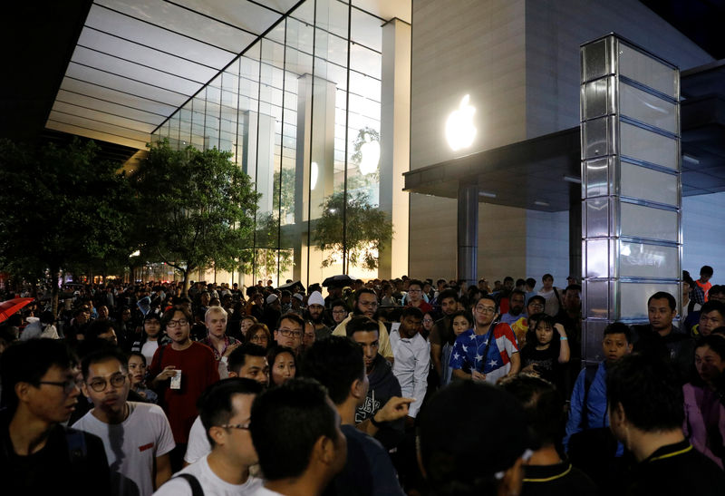 © Reuters. Pessoas passam a noite em fila para o lançamento do iPhone em loja da Apple em Cingapura