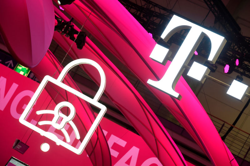 © Reuters. FILE PHOTO: Deutsche Telekom logo is seen during preparations at the CeBit computer fair in Hanover