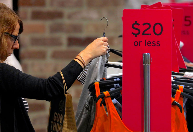 © Reuters. A shopper looks at clothes on sale at a retail store located in a shopping mall in central Sydney, Australia