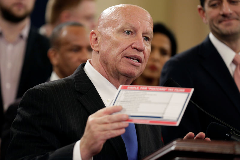 © Reuters. Chairman of the House Ways and Means Committee Kevin Brady (R-TX) holds a sample tax form as he unveils legislation to overhaul the tax code on Capitol Hill in Washington