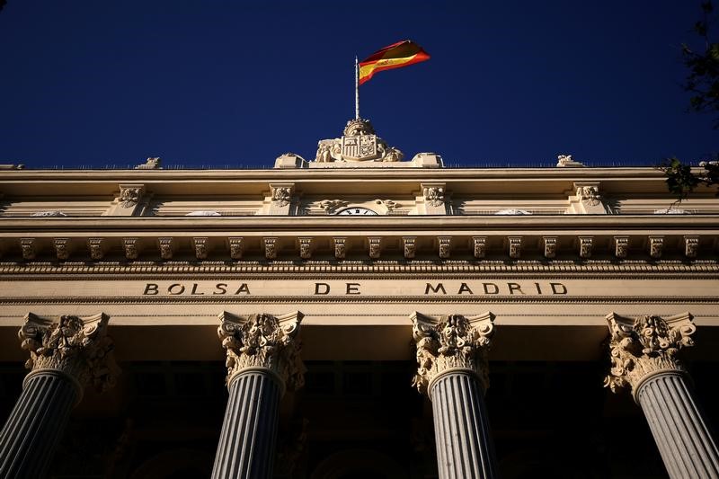 © Reuters. FILE PHOTO: A Spanish flag flutters above the Madrid Stock Exchange