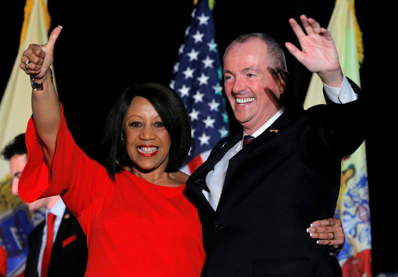 © Reuters. FILE PHOTO: Murphy and Oliver celebrate after being elected Governor of New Jersey in Asbury Park