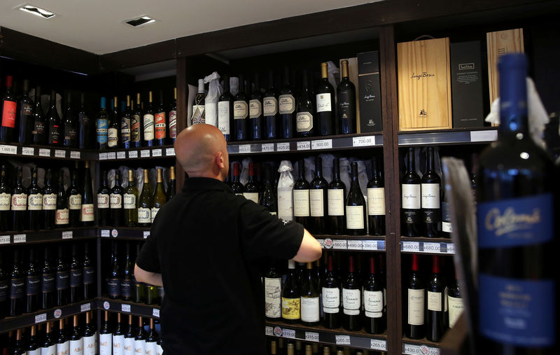 © Reuters. A man works inside a wine store in Buenos Aires