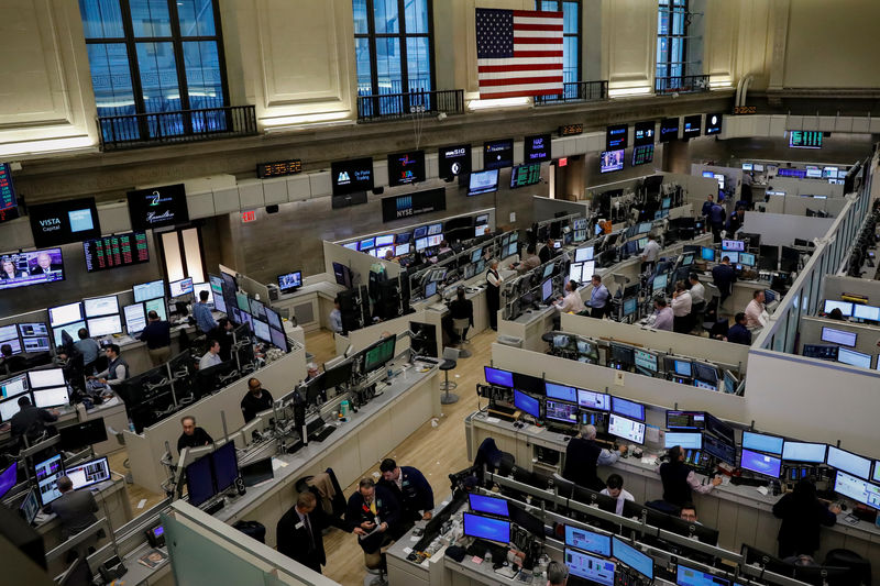 © Reuters. FILE PHOTO: Traders work on the floor of the American Stock Exchange (AMEX) at the NYSE in New York