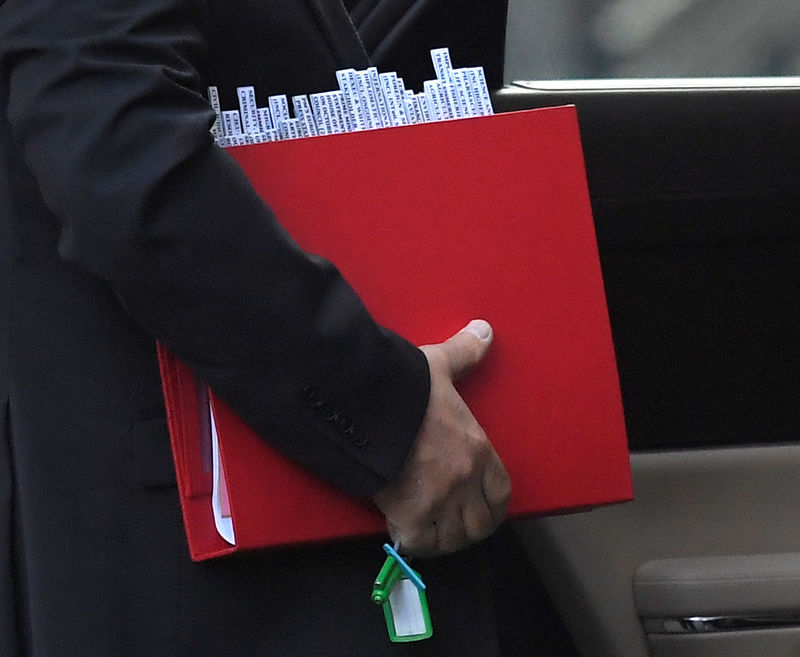 © Reuters. The driver for Britain's Secretary of State for Exiting the European Union David Davis carries the minister's folder from his car in Downing Street, London