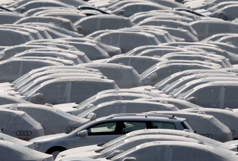© Reuters. FILE PHOTO: New VW cars covered with protective covers on a transport ship at Emden harbour