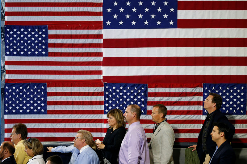 © Reuters. People listen as U.S. President Donald Trump speaks about tax reform in Harrisburg, Pennsylvania