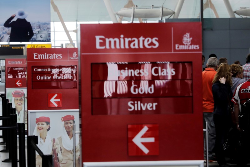 © Reuters. FILE PHOTO: Signs point to the Emirates Airlines check in desks at JFK International Airport in New York