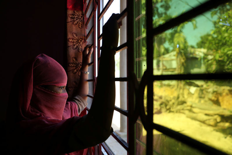 © Reuters. A 12 year old Rohingya girl who worked as domestic help in a house in Bangladesh, looks out the window at an undisclosed location near Cox's Bazar