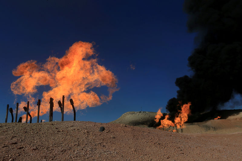 © Reuters. FILE PHOTO: Flames emerge from flare stacks at the oil fields in Dibis area on the outskirts of Kirkuk