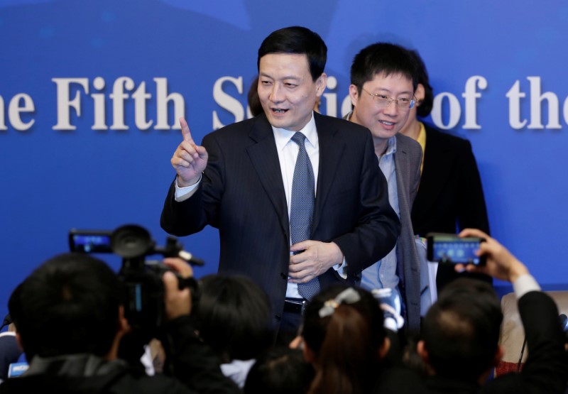 © Reuters. FILE PHOTO: The director of China's state assets regulator Xiao Yaqing speaks to the media in Beijing