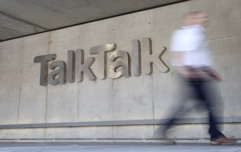 © Reuters. A man passes a branded logo outside the Talktalk headquarters in London