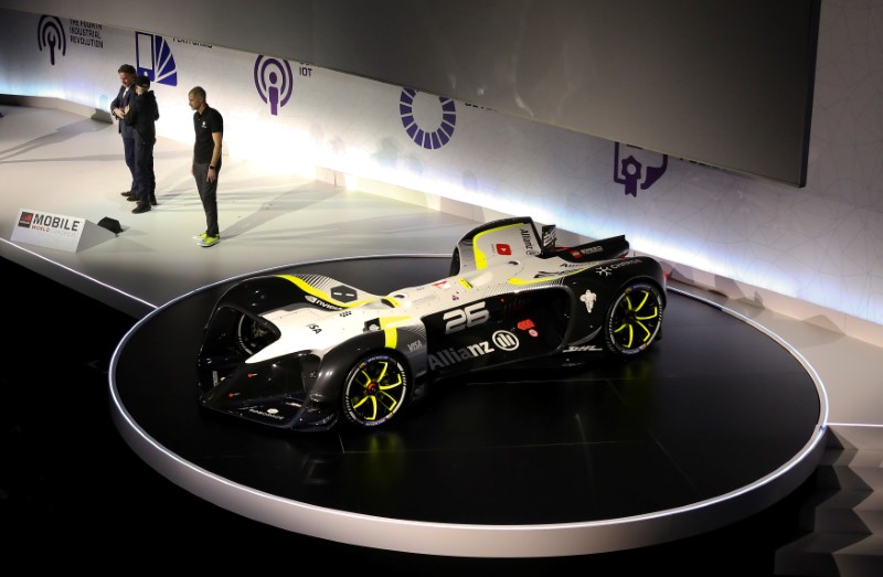 © Reuters. FILE PHOTO: Agag, CEO of Formula E Holding, Sverdlov, CEO of Roborace and Charge,and Simon, Chief Design Officer of Roborace and Charge, stand on the stage after unveiling Roborace's self-driving racing car during Mobile World Congress in Barcelona