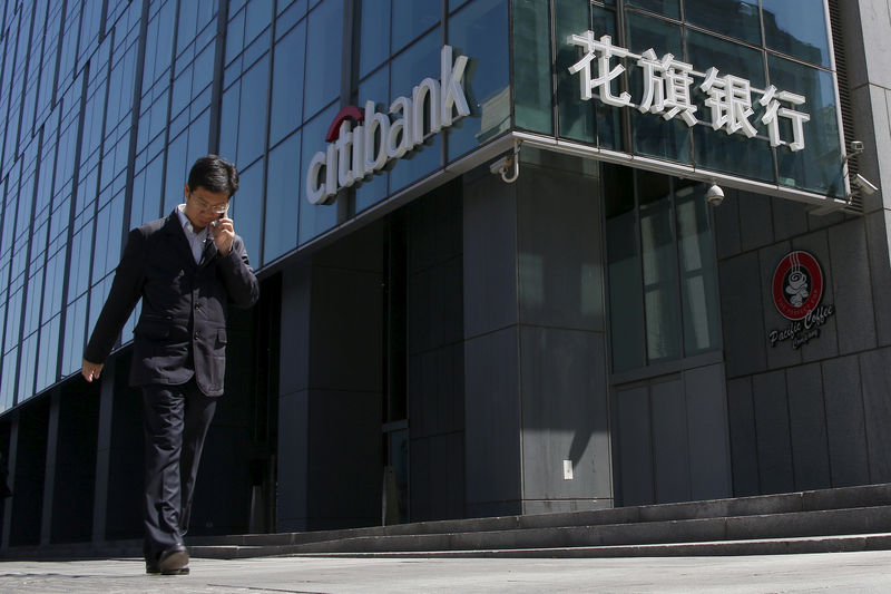 © Reuters. FILE PHOTO: A man walks past a branch of Citibank in Beijing