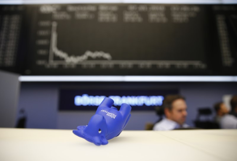 © Reuters. A styrofoam bull figure lies on its side in front of DAX board at Frankfurt's stock exchange