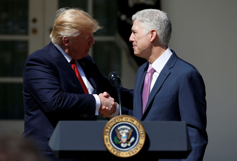 © Reuters. FILE PHOTO: President Donald Trump shakes hands with Judge Neil Gorsuch after he was sworn in as an Associate Supreme Court in the Rose Garden of the White House in Washington