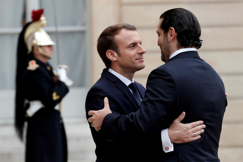 © Reuters. French President Emmanuel Macron and Saad al-Hariri, who announced his resignation as Lebanon's prime minister while on a visit to Saudi Arabia, embrace in the courtyard of the Elysee Palace in Paris