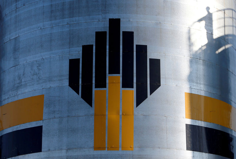 © Reuters. FILE PHOTO: Shadow of worker is seen next to logo of Russia's Rosneft oil company at central processing facility of Rosneft-owned Priobskoye oil field outside Nefteyugansk