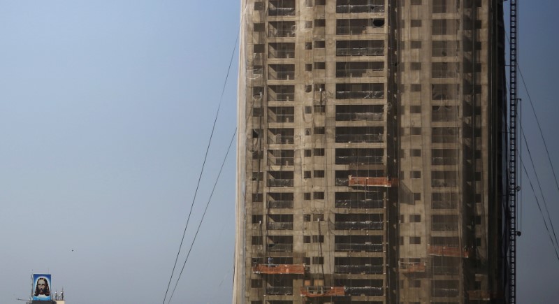 © Reuters. Picture depicting Jesus Christ is seen next to a construction site of a residential building in Sao Paulo