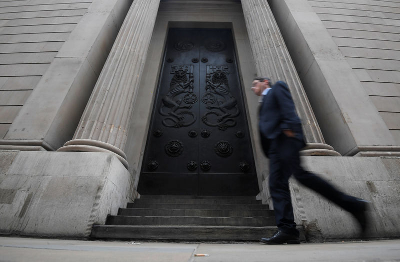 © Reuters. A man walks past the Bank of England in the City of London