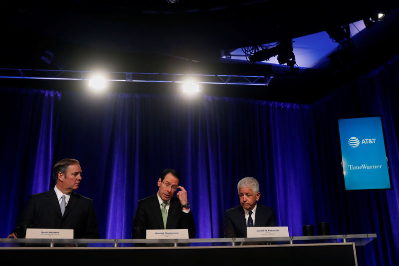 © Reuters. Chief Executive Officer of AT&T Randall Stephenson sits with David McAtee, SEVP and General Counsel for AT&T, and Daniel Petrocelli, counsel from O'Melveny & Myers LLP., during a press conference in New York City