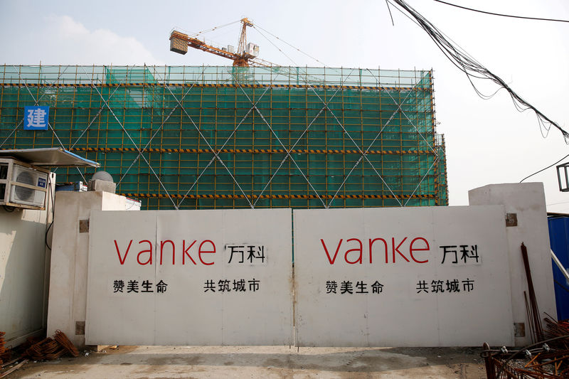 © Reuters. FILE PHOTO: Sign of Vanke is seen at a gate of a construction site in Shanghai