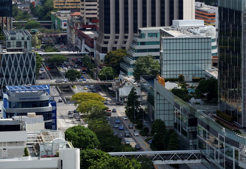 © Reuters. Cars ply the roads in downtown Singapore