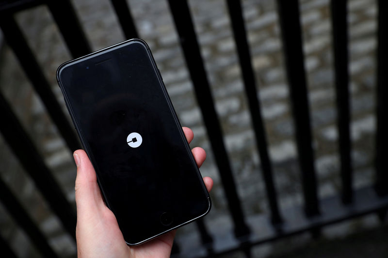 © Reuters. FILE PHOTO: The Uber logo is seen on mobile telephone in London