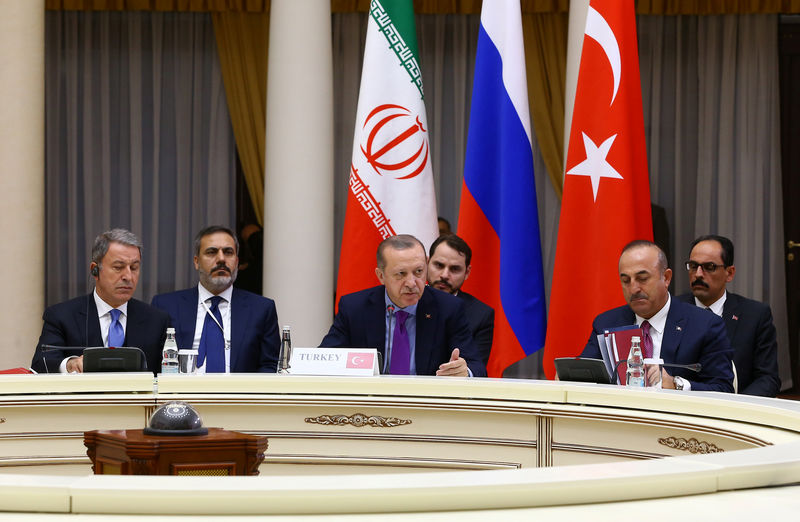 © Reuters. Turkish President Erdogan speaks during a meeting with his counterparts Putin of Russia and Rouhani of Iran in Sochi
