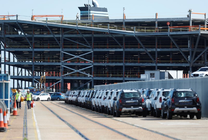 © Reuters. Cars readied for export are parked next to a vehicle storage facility on the dockside at the ABP port in Southampton