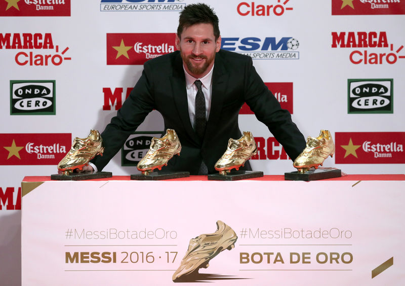 © Reuters. Barcelona's Lionel Messi poses with his four Golden Boot trophies during a ceremony in Barcelona