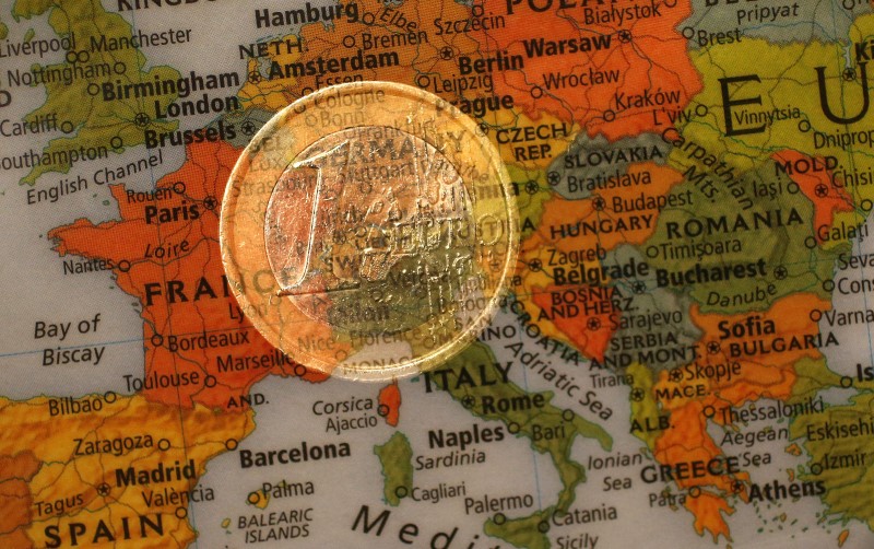 © Reuters. A picture illustration taken with the multiple exposure function of the camera shows a one Euro coin and a map of Europe