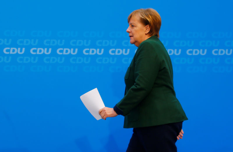 © Reuters. Acting Chancellor Angela Merkel attends a news conference at the Christian Democratic Union headquarters in Berlin