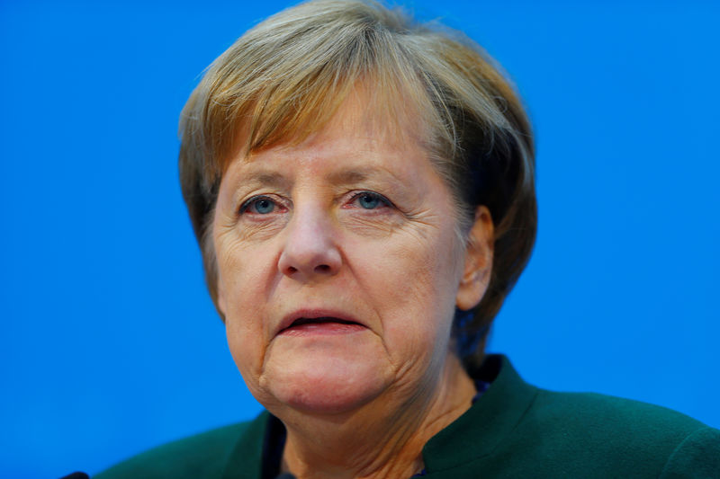 © Reuters. Acting Chancellor Angela Merkel attends a news conference at the Christian Democratic Union headquarters in Berlin