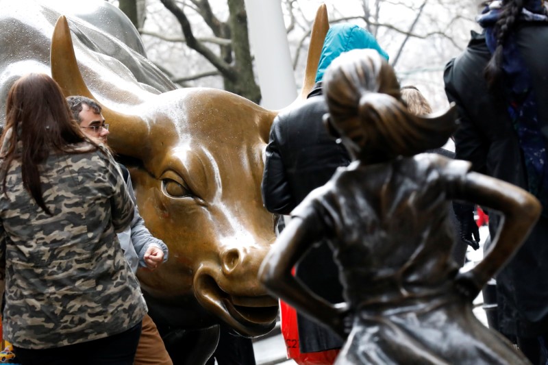 © Reuters. A statue of a girl facing the Wall St. Bull is seen in the financial district in New York