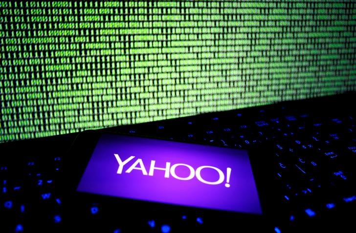 © Reuters. A photo illustration shows a Yahoo logo on smartphone in front of a displayed cyber code and keyboard