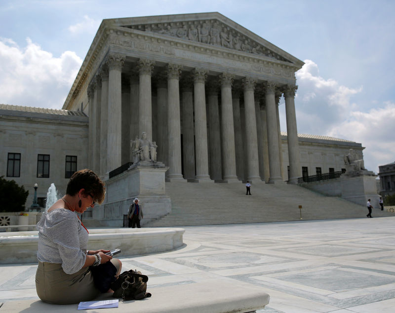 © Reuters. FILE PHOTO: Kristen Luna uses her mobile device at the plaza of the U.S. Supreme Court in Washington