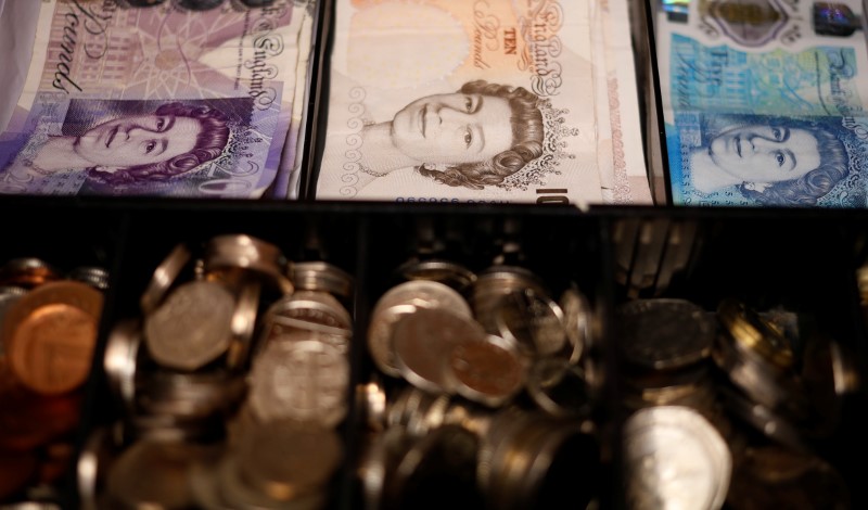 © Reuters. Pound notes and coins are seen inside a cash register in a bar in Manchester, Britain
