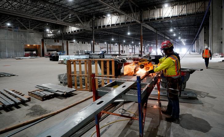 © Reuters. A worker cuts a metal stud in the convention center part of the Gaylord Rockies Resort & Convention Center under construction outside Denver