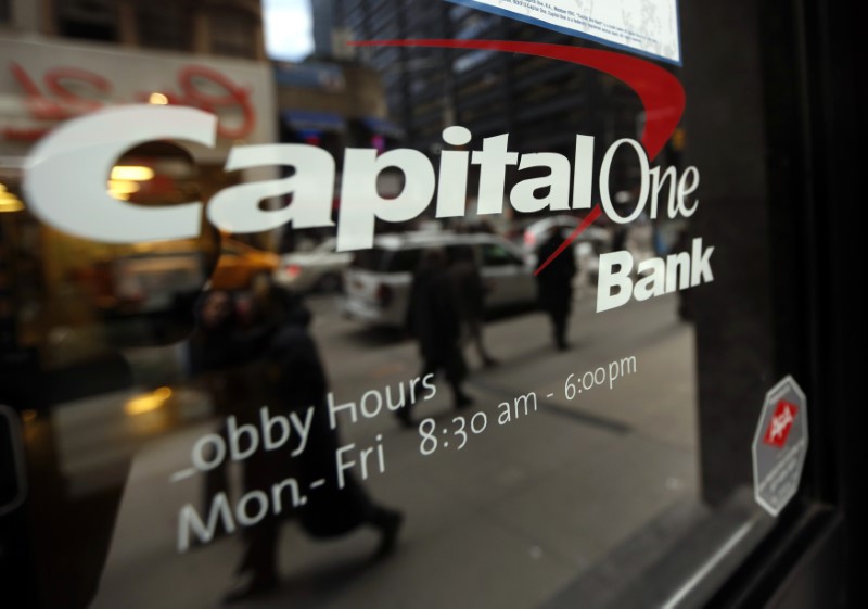 © Reuters. People walk past a Capital One banking center in New York's financial district