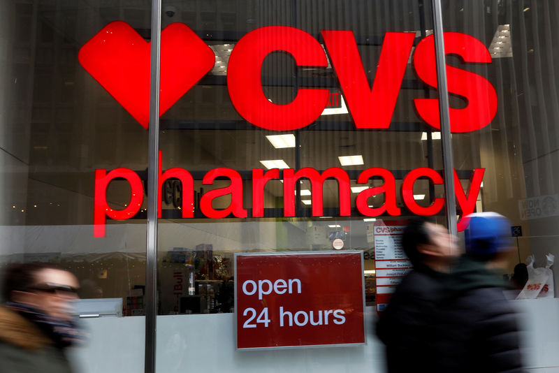 © Reuters. FILE PHOTO: People walk by a CVS Pharmacy store in the Manhattan borough of New York City