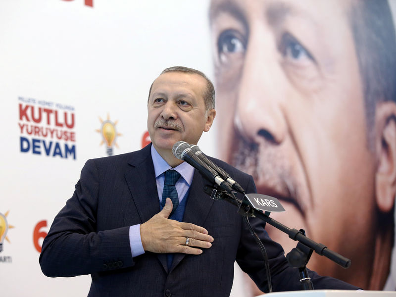 © Reuters. Turkish President Erdogan greets his supporters during a meeting of his ruling AK Party in Kars