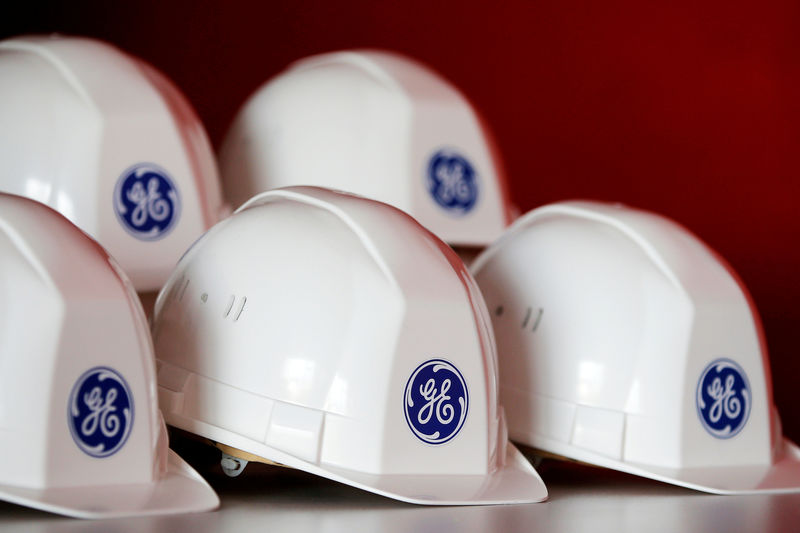 © Reuters. FILE PHOTO: The General Electric logo is pictured on working helmets during a visit at the General Electric offshore wind turbine plant in Montoir-de-Bretagne