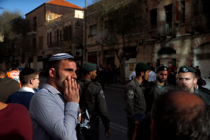 © Reuters. An onlooker reacts near the area where police said a Palestinian stabbed an Israeli security guard at the main bus station in Jerusalem