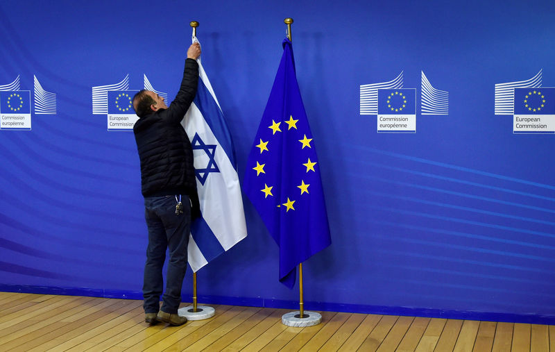 © Reuters. Funcionário remove bandeira de Israel, na sede da Comissão Europeia em Bruxelas, na Bélgica