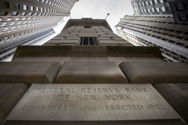 © Reuters. FILE PHOTO: The corner stone of the New York Federal Reserve Bank is seen surrounded by financial institutions in New York's financial district