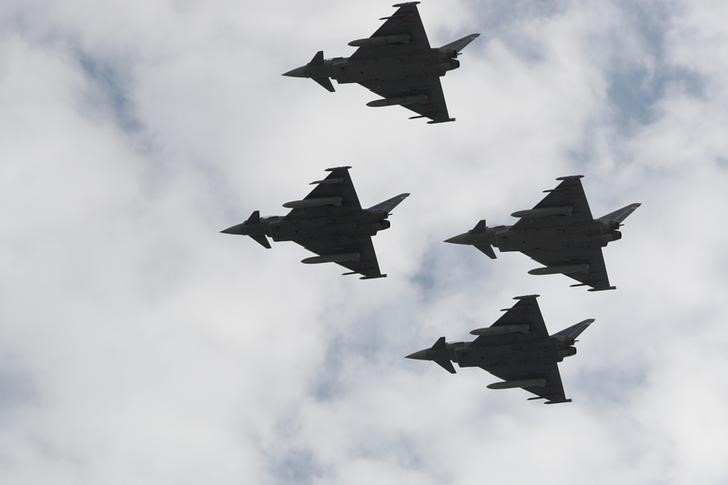 © Reuters. Eurofighter jets take part in a flypast as part of celebrations to mark Spain's National Day in Madrid