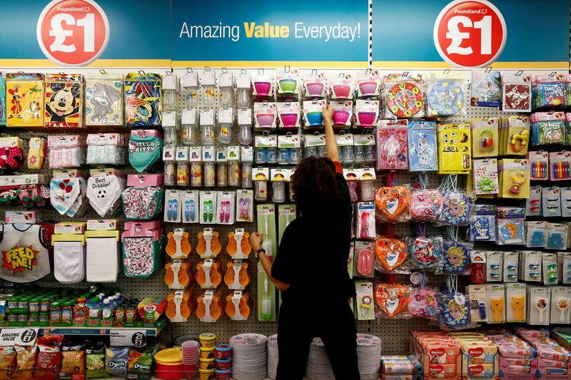 © Reuters. FILE PHOTO: A Poundland employee checks products in a store in London
