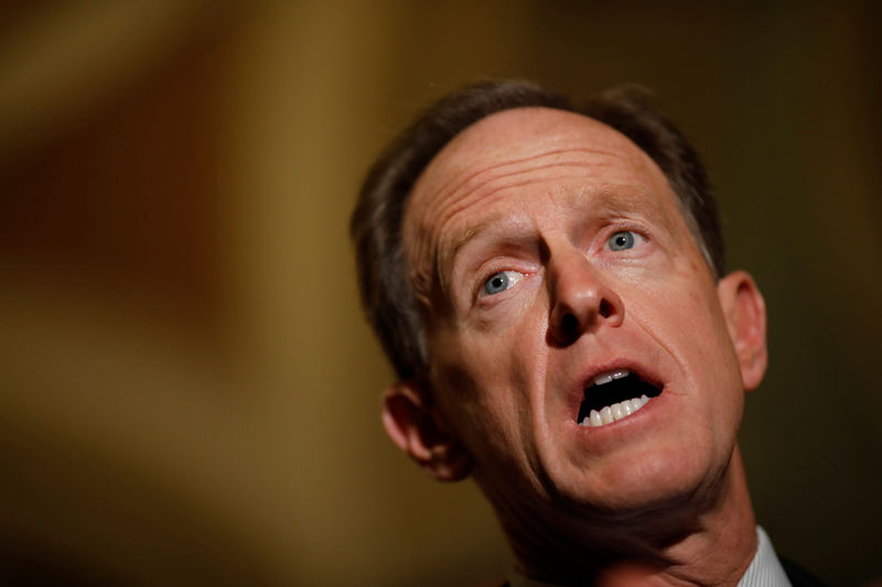 © Reuters. FILE PHOTO - Sen. Pat Toomey (R-PA) speaks with reporters following the party luncheons on Capitol Hill in Washington