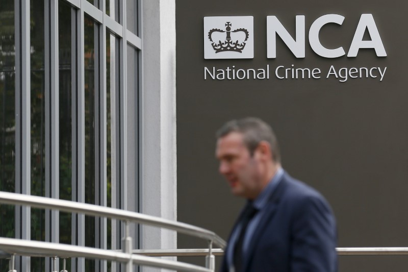 © Reuters. A pedestrian walks past the National Crime Agency headquarters in London